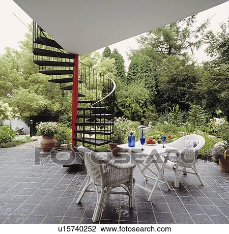 White wicker chairs on patio in large country garden in summer View Large Photo Image Stock Image - White wicker chairs on patio in large country garden in summer. Fotosearch