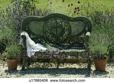 Wicker chair in country garden in summer View Large Photo Image Stock Photograph - Wicker chair in country garden in summer. Fotosearch