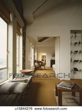 Windowseat and sisal carpet in modern living room in loft conversion View Large Photo Image Stock Photograph - Windowseat and sisal carpet in modern living room in loft conversion. Fotosearch