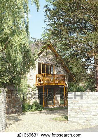 Wooden balcony on modern country house with apex roof View Large Photo Image Stock Photo - Wooden balcony on modern country house with apex roof. Fotosearch