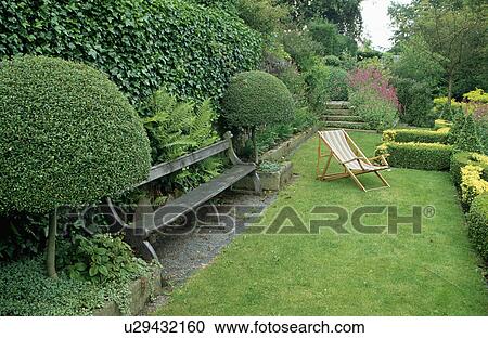Wooden bench in country garden in summer View Large Photo Image Stock Image - Wooden bench in country garden in summer. Fotosearch
