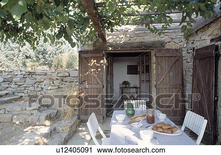 Wooden pergola above table on patio of small Mediterranean house View Large Photo Image Stock Image - Wooden pergola above table on patio of small Mediterranean house. Fotosearch