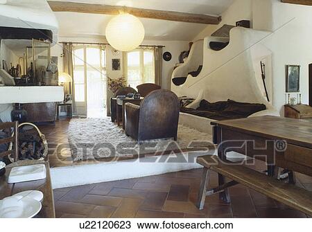 Wooden table and bench in rustic split-level dining and living room View Large Photo Image Stock Image - Wooden table and bench in rustic split-level dining and living room. Fotosearch