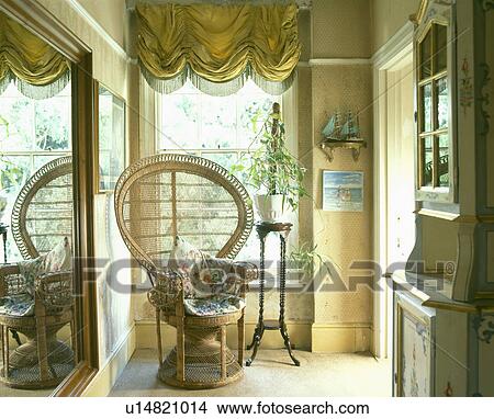 Yellow festoon blind above Peacock chair in hall View Large Photo Image Picture - Yellow festoon blind above Peacock chair in hall. Fotosearch