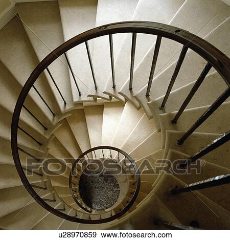 Stock Photo - Aerial view of circular stone staircase with metal bannisters. Fotosearch
