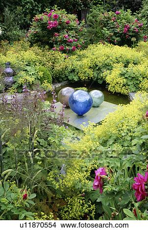Alchemilla mollis surrounding mall water feature with glass globes in country garden View Large Photo Image Picture - Alchemilla mollis surrounding mall water feature with glass globes in country garden. Fotosearch
