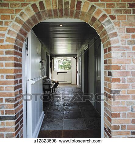 Arched doorway entrance with open stable door looking into stone flagged hallway. View Large Photo Image Stock Photo - Arched doorway entrance with open stable door looking into stone flagged hallway.. Fotosearch