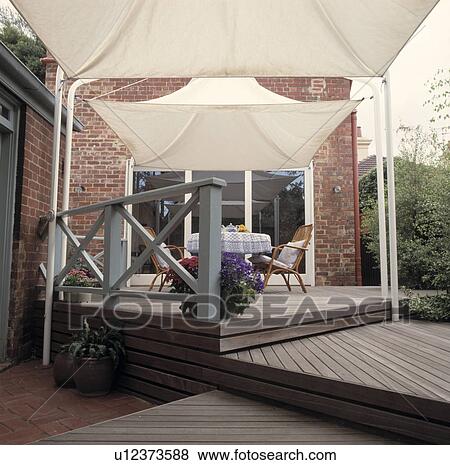 Stock Photo - Architectural decked terrace with white canvas canopies. Fotosearch