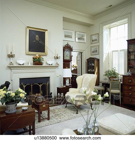 Armchair beside fireplace in traditional living room View Large Photo Image Stock Image - Armchair beside fireplace in traditional living room. Fotosearch