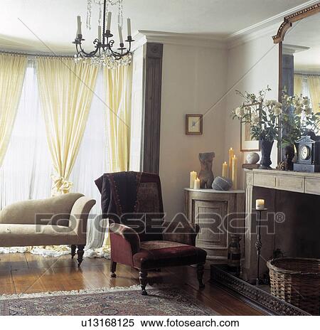 armchair beside fireplace in uncluttered living room View Large Photo Image Stock Photography - armchair beside fireplace in uncluttered living room. Fotosearch
