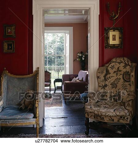 Armchairs beside doorway in red living room View Large Photo Image Picture - Armchairs beside doorway in red living room. Fotosearch