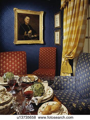 Artichokes and bread on table in restaurant dining room with yellow+white curtain and red and blue chairs View Large Photo Image Stock Photo - Artichokes and bread on table in restaurant dining room with yellow+white curtain and red and blue chairs. Fotosearch