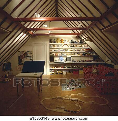 Stock Image - Attic playroom with wal of shelving. Fotosearch