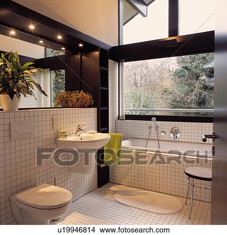 Beige bathroom in modern house with picture window View Large Photo Image Picture - Beige bathroom in modern house with picture window. Fotosearch