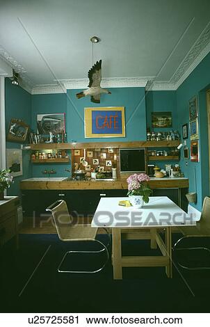 Bird mobile over white table in turquoise seventies kitchen View Large Photo Image Stock Image - Bird mobile over white table in turquoise seventies kitchen. Fotosearch