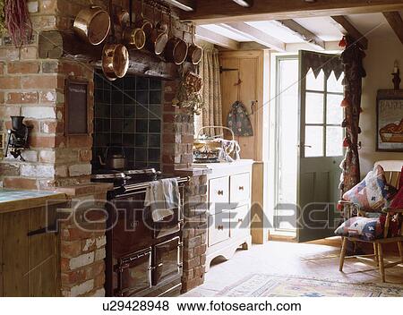 Black Aga in brick fireplace in cottage kitchen View Large Photo Image Stock Photo - Black Aga in brick fireplace in cottage kitchen. Fotosearch