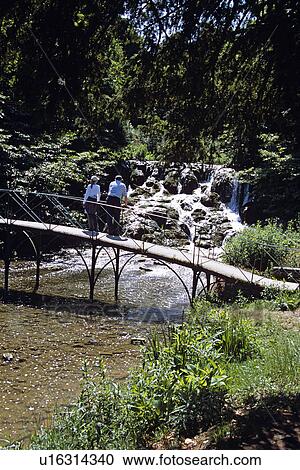 Blenheim Palace, Woodstock, near Oxford, Oxfordshire, England. Visitors on bridge overlooking waterfall. View Large Photo Image Stock Image - Blenheim Palace, Woodstock, near Oxford, Oxfordshire, England. Visitors on bridge overlooking waterfall.. Fotosearch