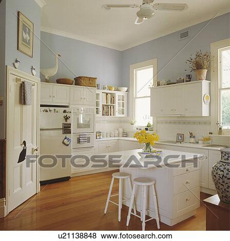 Blue and white family kitchen with island unit and breakfast bar View Large Photo Image Stock Photo - Blue and white family kitchen with island unit and breakfast bar. Fotosearch