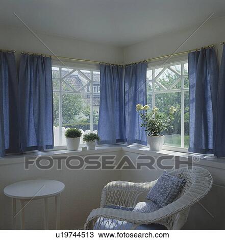Blue curtains in white living room View Large Photo Image Stock Image - Blue curtains in white living room. Fotosearch