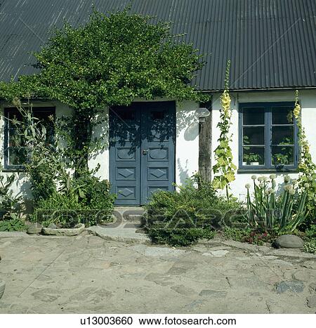 Blue door in traditional white single-storey country cottage View Large Photo Image Stock Image - Blue door in traditional white single-storey country cottage. Fotosearch