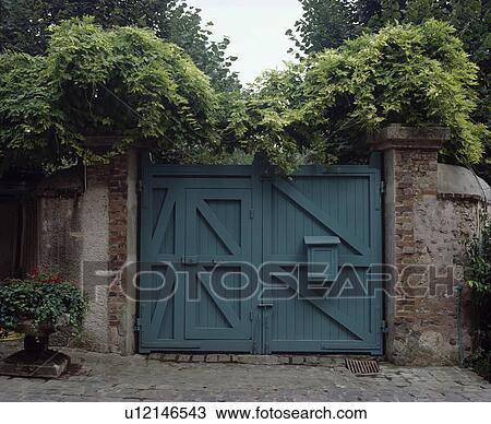 Blue gates in walled garden View Large Photo Image Stock Image - Blue gates in walled garden. Fotosearch