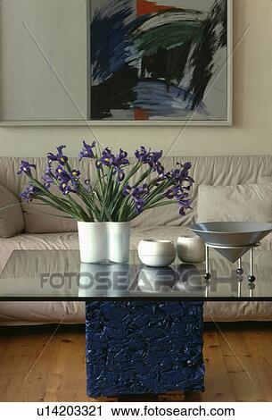 Blue irises on glass table in modern living room View Large Photo Image Stock Image - Blue irises on glass table in modern living room. Fotosearch