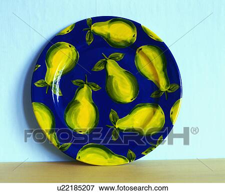 Stock Photo - Blue pottery plate with yellow pear design. Fotosearch