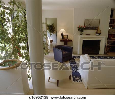 Blue tub armchair and white sofa in modern white living room View Large Photo Image Stock Photo - Blue tub armchair and white sofa in modern white living room. Fotosearch