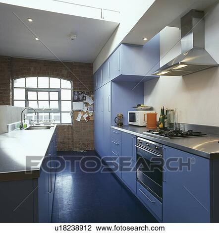 Blue units and flooring in loft conversion kitchen View Large Photo Image Stock Image - Blue units and flooring in loft conversion kitchen. Fotosearch