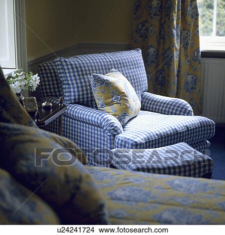 Picture - Blue+white checked armchair and stool in corner of traditional bedroom&#13; &#10; &#13; &#10; &#13; &#10; &#13; &#10; &#13; &#10; &#13; &#10;. Fotosearch
