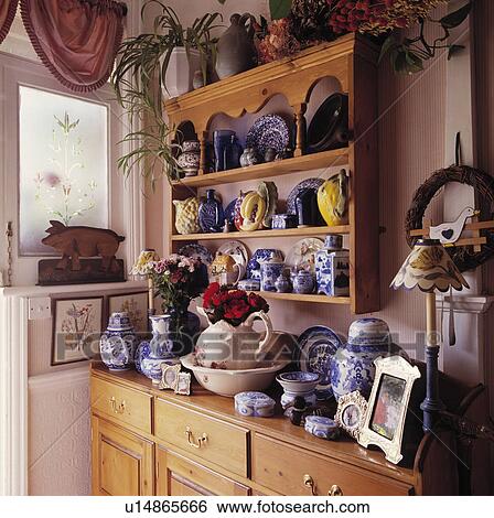 Blue+white crockery on pine shelves above pine kitchen cupboard View Large Photo Image Stock Photograph - Blue+white crockery on pine shelves above pine kitchen cupboard. Fotosearch