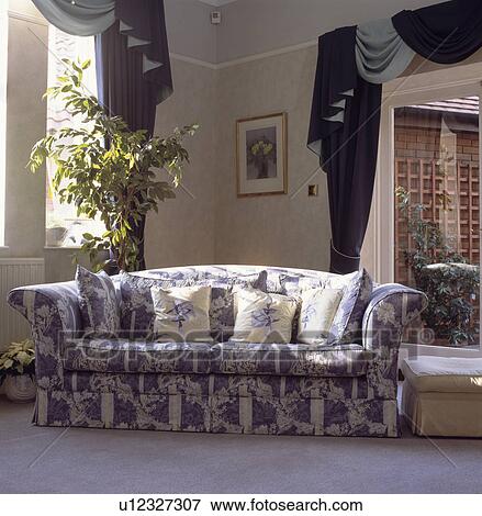 Stock Photo - Blue+white floral sofa in traditional living room. Fotosearch