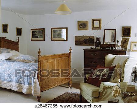 Blue White Quilt On Antique Wooden Bed In White Cottage