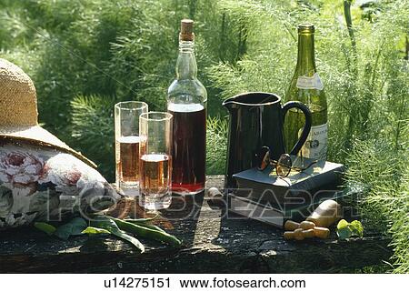 Bottles of wine and cordial on garden table View Large Photo Image Stock Image - Bottles of wine and cordial on garden table. Fotosearch