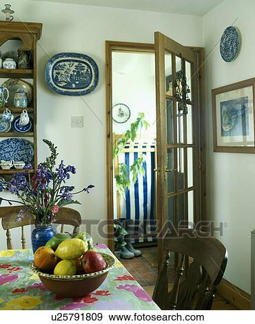 bowl of fruit on floral table cloth in small dining room with glass door open to hall View Large Photo Image Stock Photo - bowl of fruit on floral table cloth in small dining room with glass door open to hall. Fotosearch