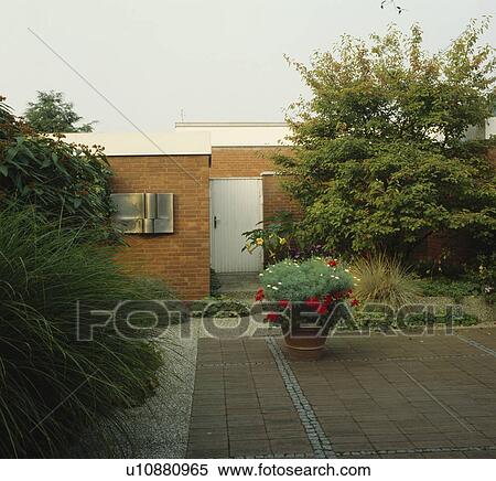 Brick paving in front of small modern house View Large Photo Image Stock Photography - Brick paving in front of small modern house. Fotosearch