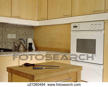 Butcher's block in modern pale wood kitchen with white oven View Large Photo Image Picture - Butcher's block in modern pale wood kitchen with white oven. Fotosearch