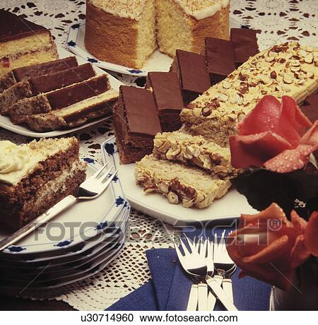 Stock Image - cake, sponge, food, forks, plates, flowers. Fotosearch
