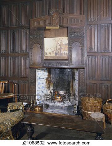 Carved Panelling With Picture Above Fireplace With Delft Tiles In