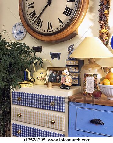 Checked fabric on drawers of small cupboard below circular clock View Large Photo Image Stock Photography - Checked fabric on drawers of small cupboard below circular clock. Fotosearch