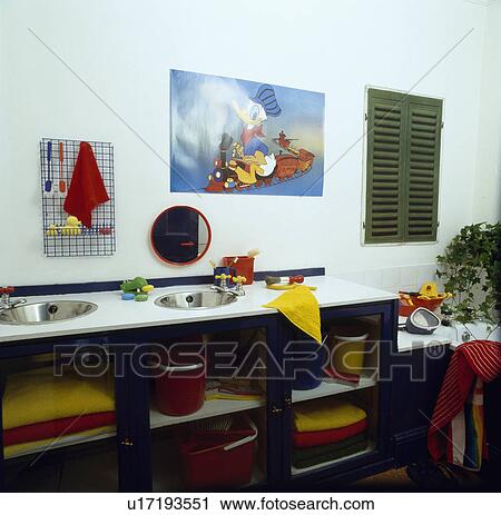 Children's bathroom with underset stainless steel double basins in vanity unit with colourful towels on open shelves View Large Photo Image Stock Image - Children's bathroom with underset stainless steel double basins in vanity unit with colourful towels on open shelves. Fotosearch