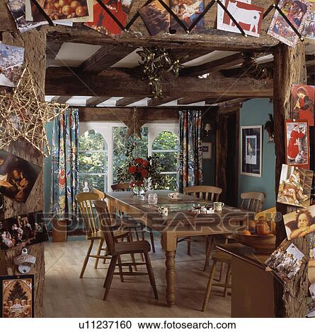 Christmas Cards And Decorations On Doorway To Cottage Dining Room