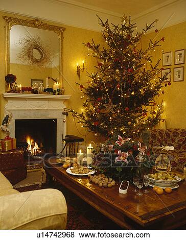 Christmas tree in traditonal yellow living room View Large Photo Image Stock Photo - Christmas tree in traditonal yellow living room. Fotosearch