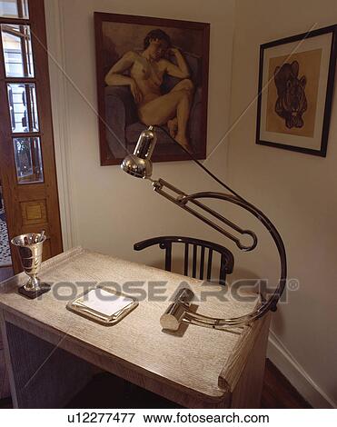 Stock Photo - Chrome thirties lamp and simple desk. Fotosearch