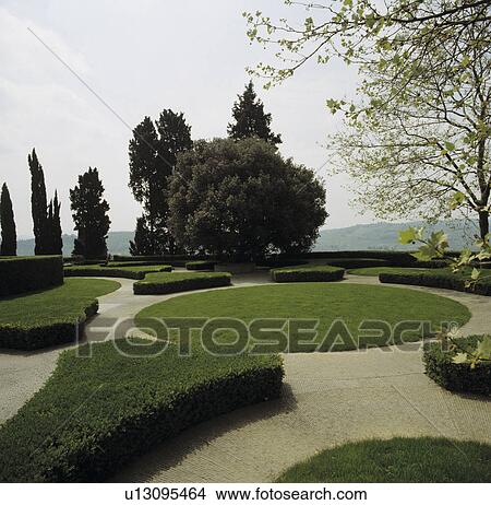 Picture - Circular lawn and gravel paths in formal Italian country garden with clipped hedging&#13; &#10;. Fotosearch