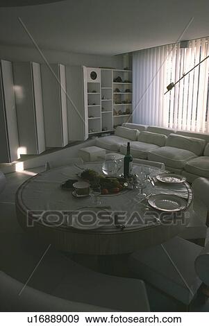 Circular table and chairs in eighties dining and living room with white sofa View Large Photo Image Stock Photo - Circular table and chairs in eighties dining and living room with white sofa. Fotosearch
