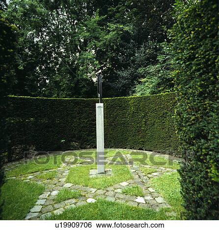 Clipped hedge in large country garden View Large Photo Image Stock Photograph - Clipped hedge in large country garden. Fotosearch