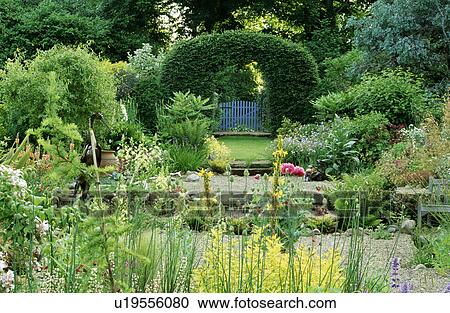 Clipped hedging arch in large country garden in summer View Large Photo Image Stock Image - Clipped hedging arch in large country garden in summer. Fotosearch