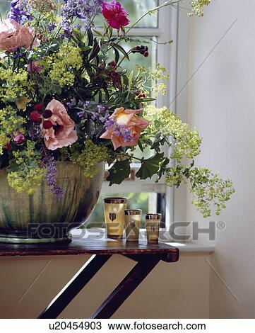 Close-up of alchemilla mollis and pink poppies and roses with horn cups on wooden table View Large Photo Image Stock Image - Close-up of alchemilla mollis and pink poppies and roses with horn cups on wooden table. Fotosearch