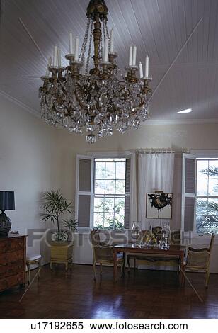 Close-up of antique crystal chandelier in white country dining room View Large Photo Image Stock Photography - Close-up of antique crystal chandelier in white country dining room. Fotosearch